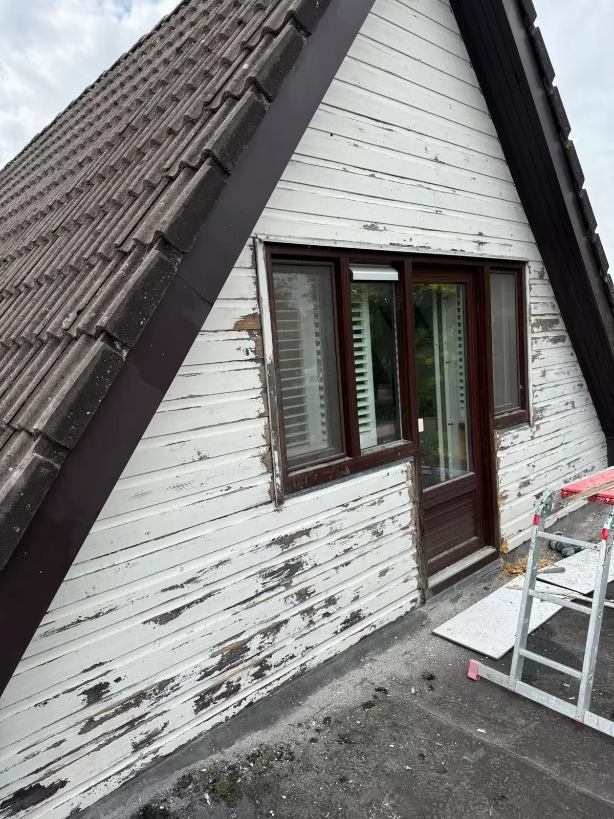 Houten gevelbekleding met oude verflagen vóór de afwerking